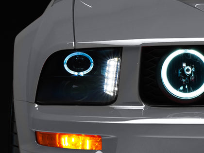 Raxiom 05-09 Ford Mustang w/ Halogen LED Halo Prjctr Headlights-Blk Hsng(Smoked Lens Exclude GT500)